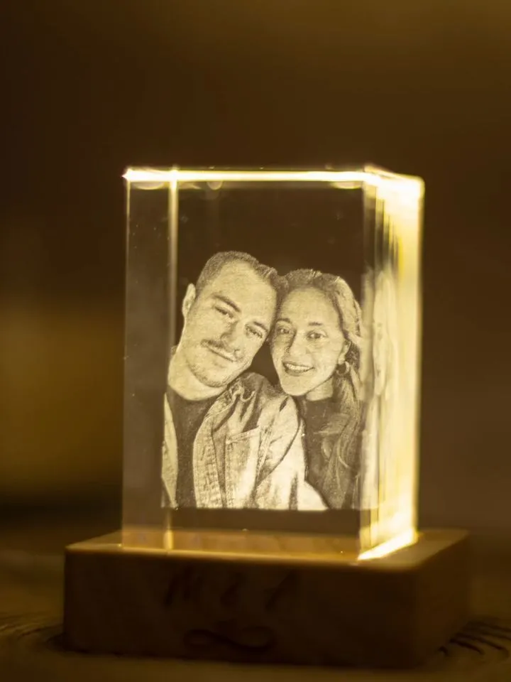 3D kristal s fotografijom para na osvijetljenom drvenom postolju